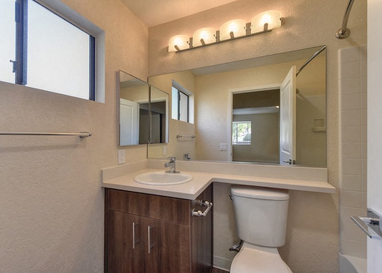 Bathroom with Toilet, Vanity, Window and Cabinets